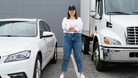 driver arms folded standing between car and truck generated with Z-Image